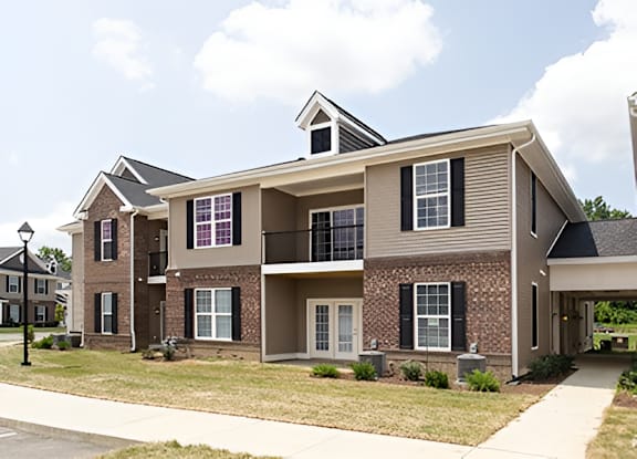 A two story house with a balcony on the second floor.