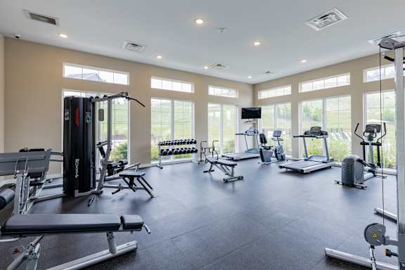 a gym with lots of windows and weights and cardio equipment at The Flats at Summit Station, South Park, 15129