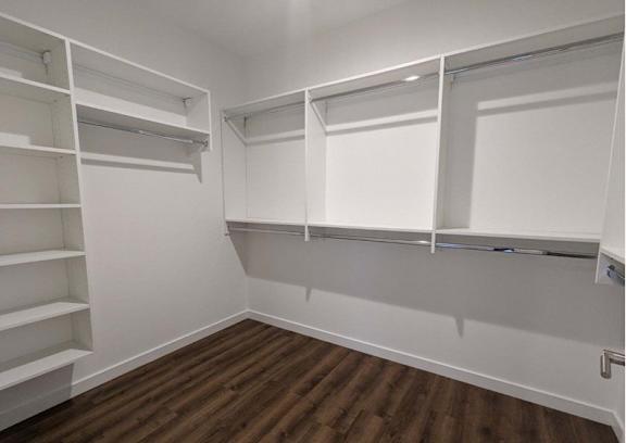 a walk in closet with white shelves at The Point at Gateways, New Jersey, 07869