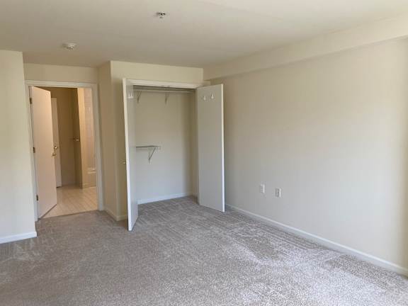 Bedroom with walk-in closet and bathroom entry