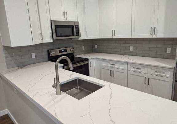 kitchen with white stone at The Point at Gateways, Randolph New Jersey