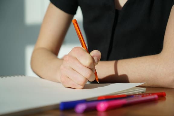 Girl Writing in Notebook at Maple Grove Rental Home Community in Lincoln, NE
