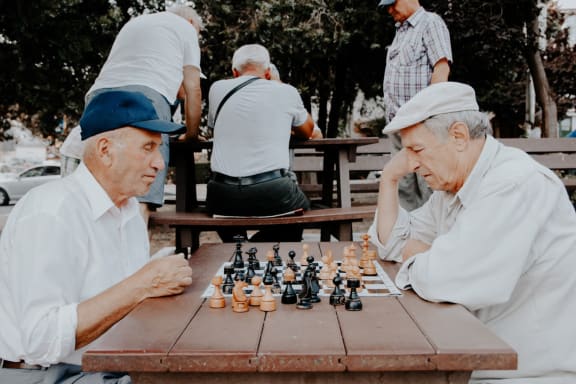 Senior People In Playing Chess at Rancho Franciscan Senior Apartments, Santa Barbara, 93105