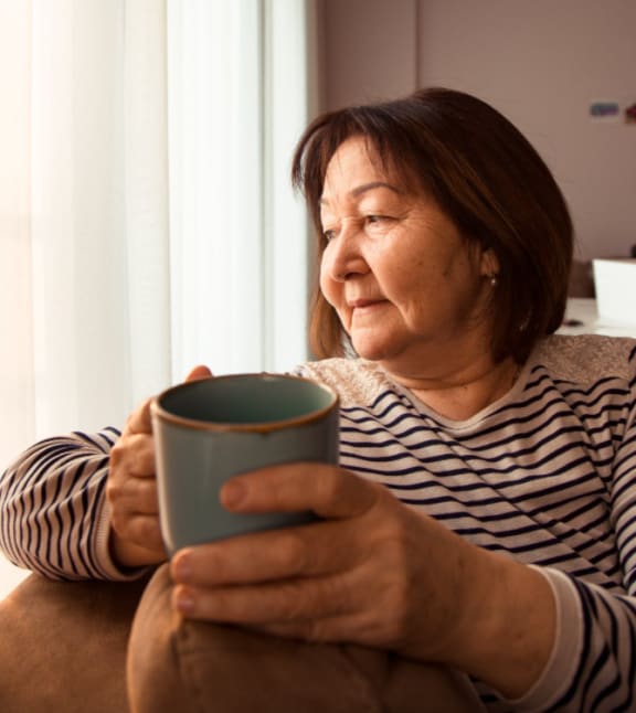 Woman With Coffee Mug at Cypress Meadows Senior Apartments, Ventura