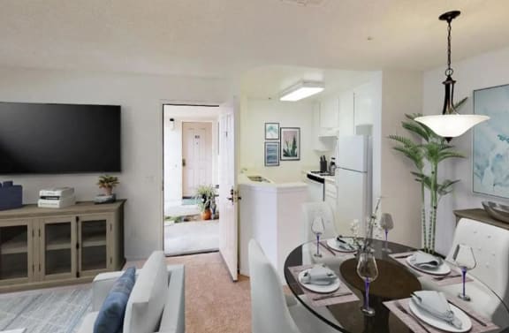 a dining area with a table and chairs and a kitchen in the background