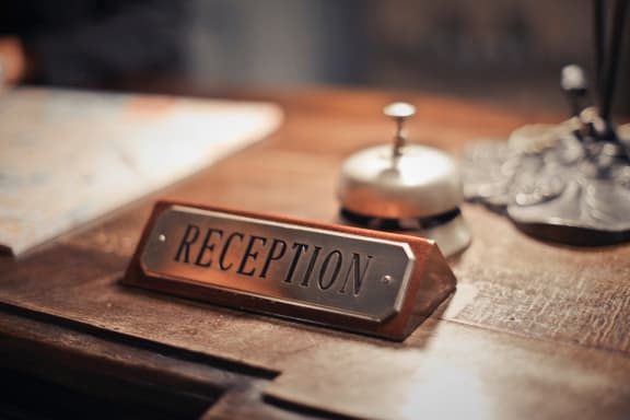 a desk with a sign that says reception