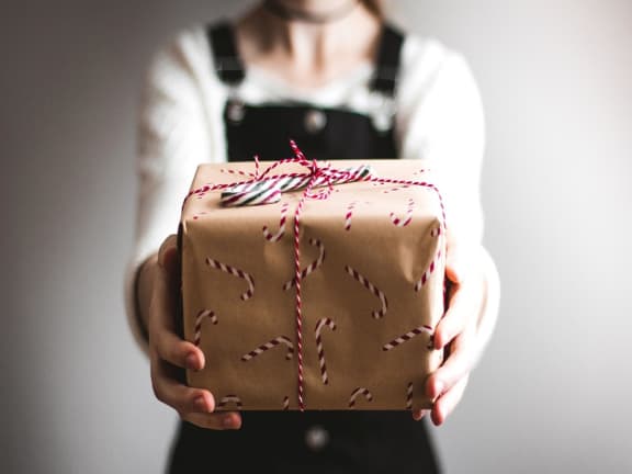 a woman holding a gift box