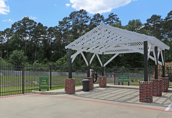 Outdoor car care pavilion.   White awning with brick open sides.