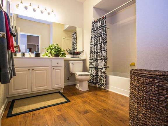 Full Model Bathroom with Faux Hard Wood Flooring at 94534 Apartments