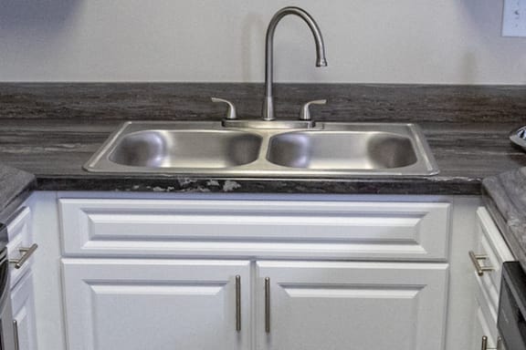 brushed nickel fixtures and stainless steel kitchen sink