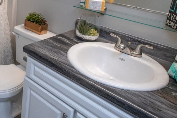 granite style bathroom countertops and nickel fixtures