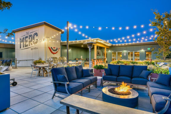 The Merc Apartments Outdoor Terrace and Firepit with Couches and Hanging Lights