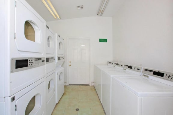 a room filled with white washers and dryers