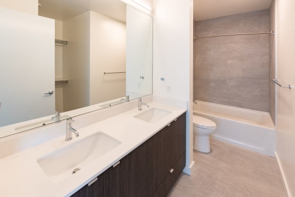 Master Bathroom with two sinks, toilet, shower at 10 Clay Apartments in Seattle, Washington
