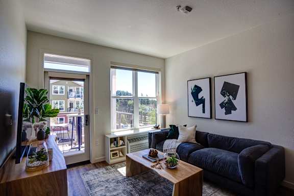 Living room with sofa, table at Commons at Sylvan Canyon Apartments, Portland, OR