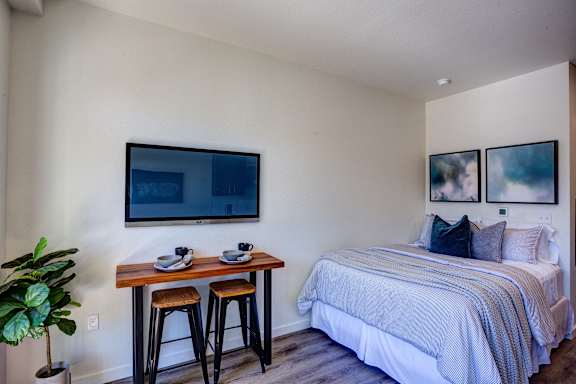 Tv, couch and bed at Commons at Sylvan Canyon Apartments, Portland, OR