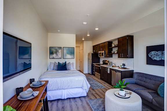 Cozy bed at Commons at Sylvan Canyon Apartments, Oregon