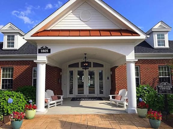 Clubhouse entrance with chairs and landscaping at Fenwyck Manor Apartments, Chesapeake, VA
