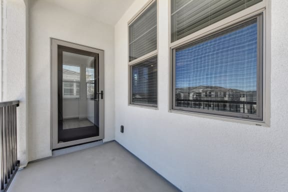 Patio Door with Entrance, Large Window and White Walls at Morgan Ranch Apartments, California