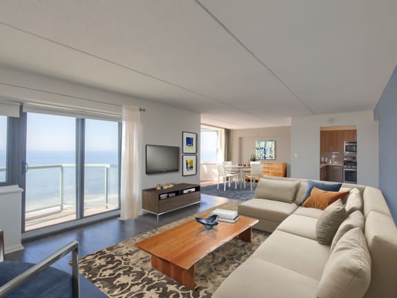 A living room with a large couch and a television at 10 West Apartments, Long Beach, 11561