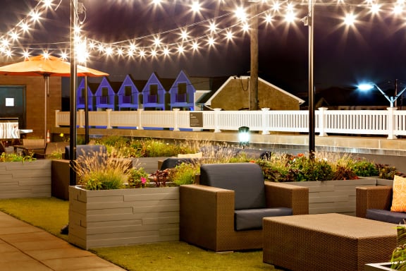 A patio area with a white picket fence and a building in the background at 10 West Apartments, New York