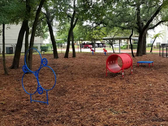 a group of children playing in a park at Monterey Ranch, Texas