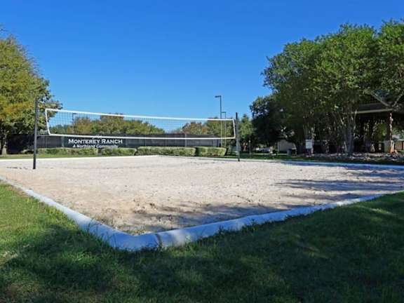 a volleyball court in a park on a sunny day at Monterey Ranch, Austin, TX