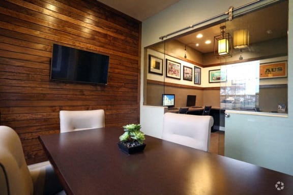 a dining room with a table and chairs and a television