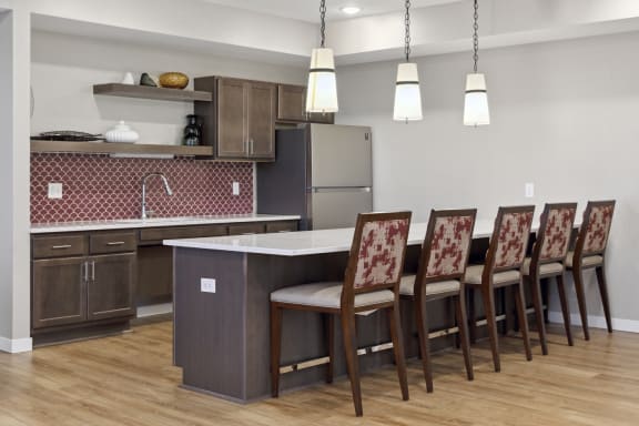 A kitchen with a table and chairs. at Sonder Point 50+ Apartments, Brooklyn Center, MN, 55430