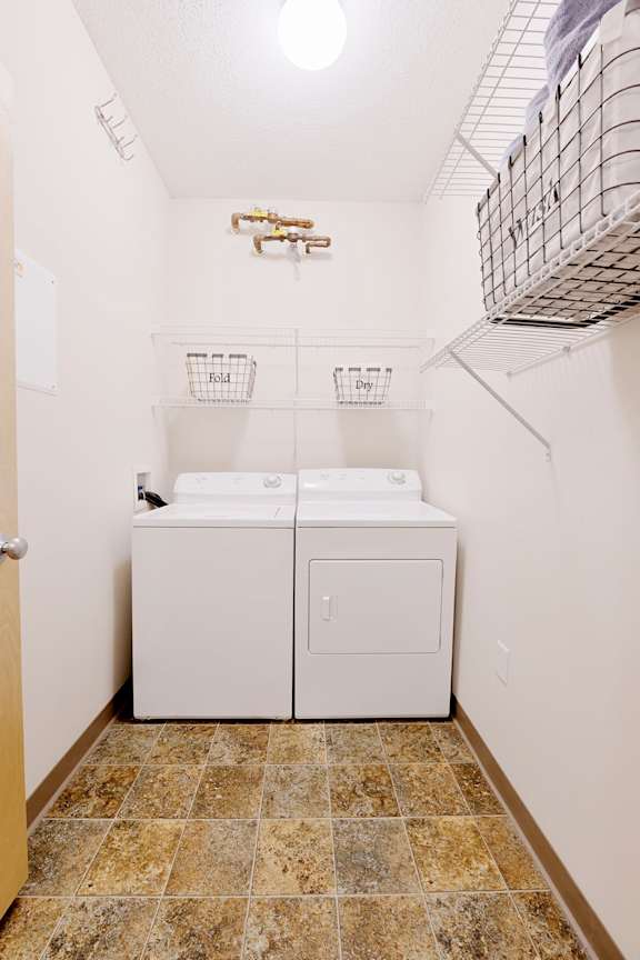 A small laundry room with a washer and dryer.