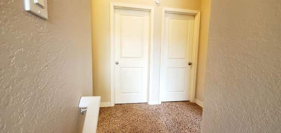 Master Bedroom door on left and a Secondary Bedroom on left at top of stairs in Fountainside  unit