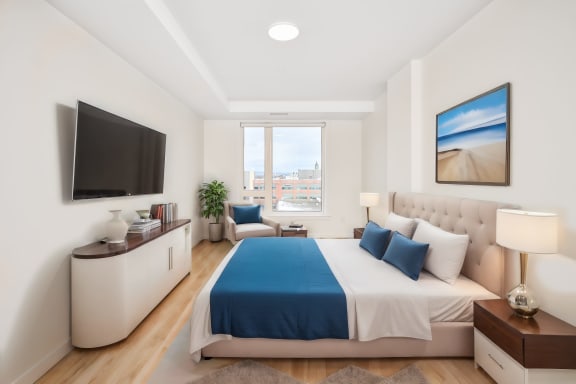 a bedroom with a bed and a tv