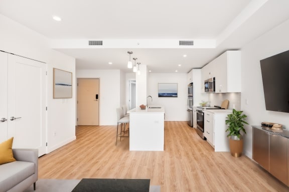 an open living room with a kitchen and a dining room
