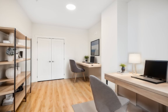 a room with a desk and a computer