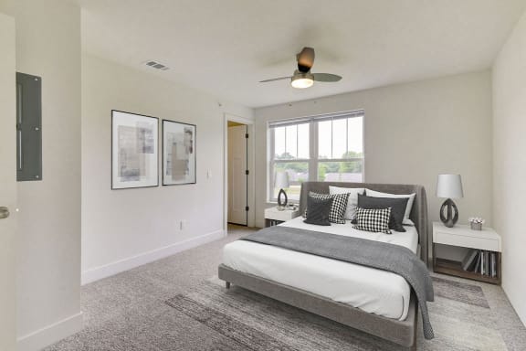 Large bedroom with walk in closet and ceiling fan at Eagle Ridge Apartment Homes, Traverse City, Michigan