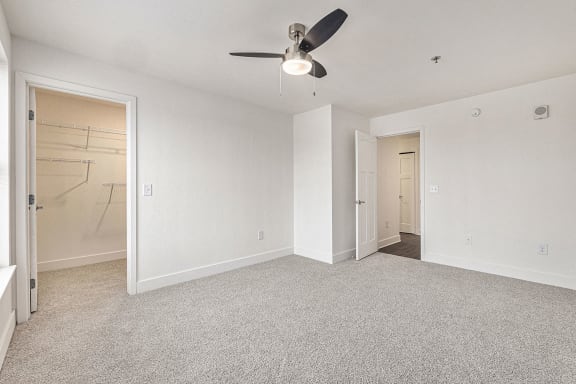 Bedroom with walk in closet with wardrobe organizers at Eagle Ridge Apartment Homes, Traverse City