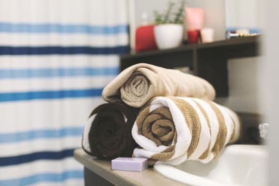 Pile of Towels in Bathroom at Pine Village Rental Home Community in Sanford, NC