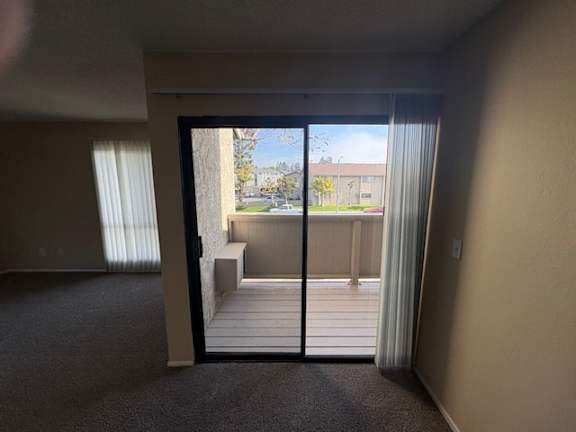 A Dining room with a sliding glass door leading to a balcony.
