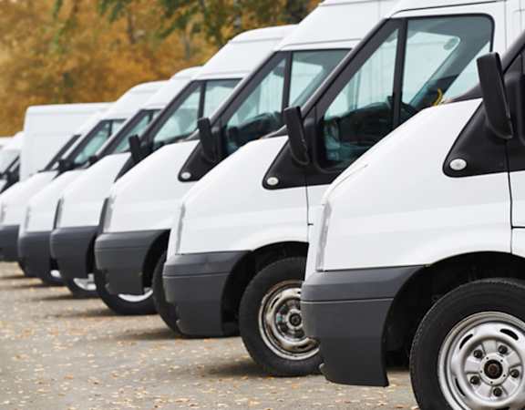 a row of white trucks parked