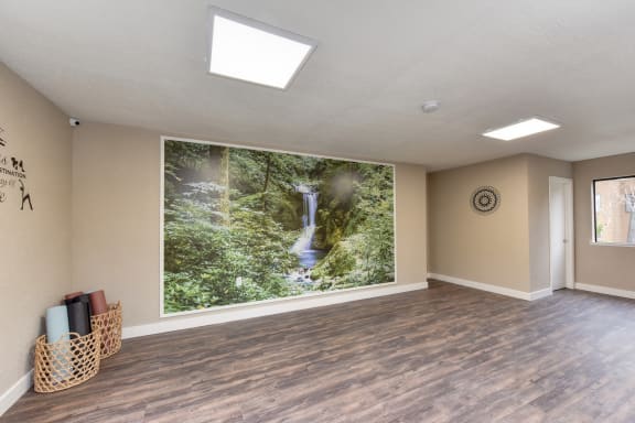 Community Yoga Studio with Hardwood Inspired Floor, Ceiling Lights, Large Window and Wicker Basket with Yoga Mats at Fountains of Fair Oaks, Fair Oaks, CA 95628