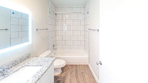 Bathroom with a garden tub, granite counters and LED lit mirror.