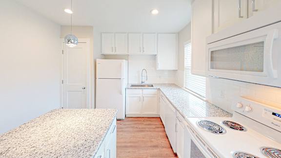 Kitchen with white cabinets and a granite countertop.