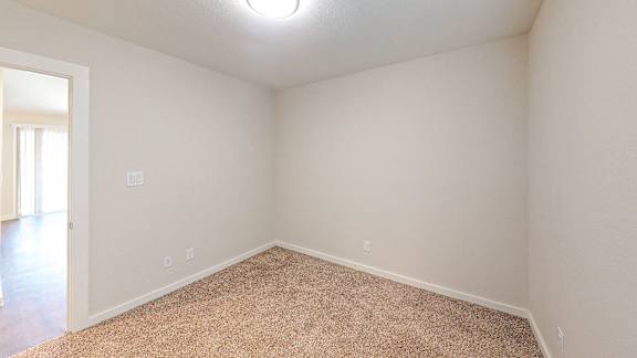 Second Bedroom with carpeted floors.