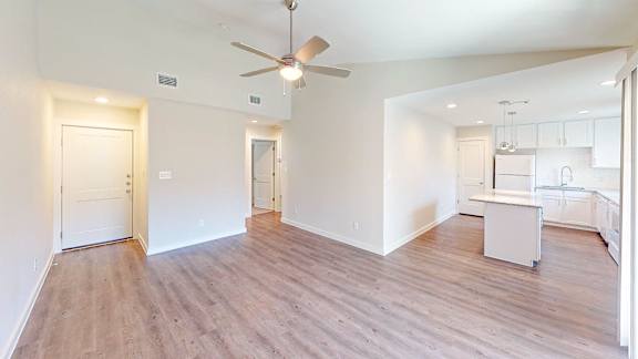 Living room with vinyl plank flooring and vaulted ceilings