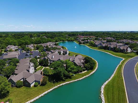Lake beside the road surrounded by apartment buildings