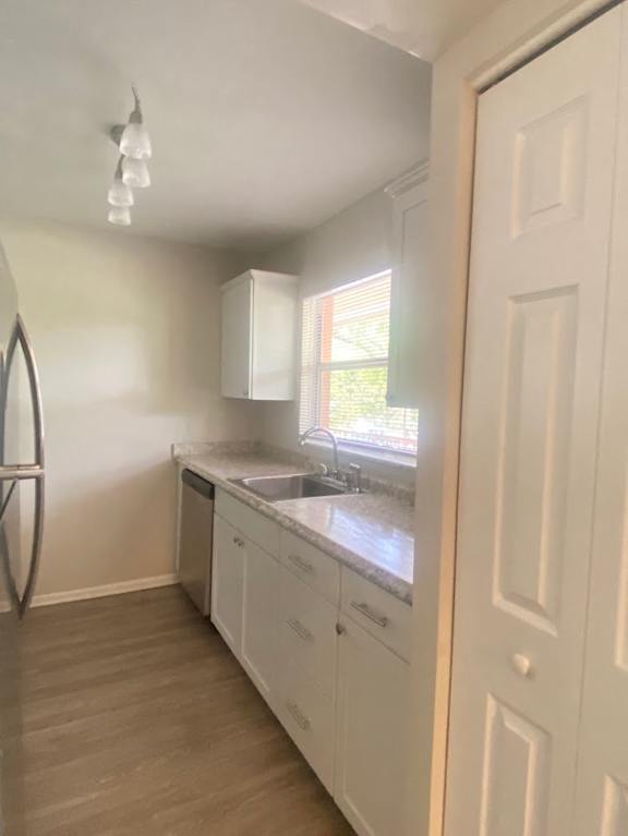 A kitchen with white cabinets and a window. at Imperial Gardens Apartments, Clearwater 33764