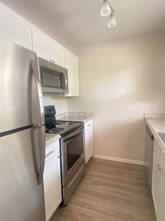 A kitchen with a stainless steel refrigerator and oven. at Imperial Gardens Apartments, Clearwater, Florida