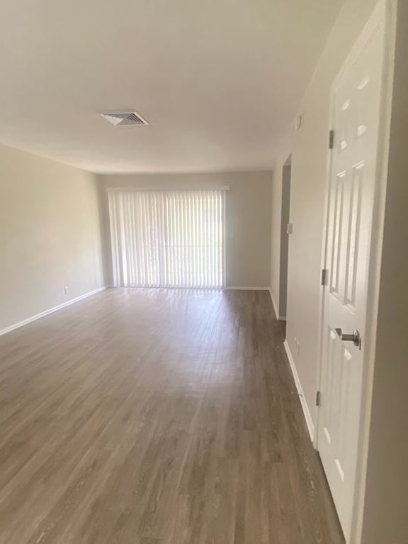 A long hallway with wood floors and white walls. at Imperial Gardens Apartments, Clearwater