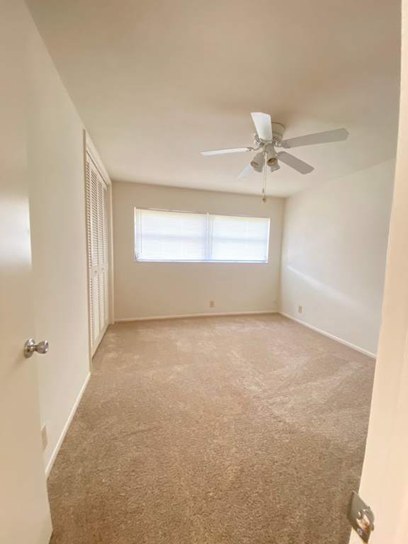 A room with a ceiling fan and a window. at Imperial Gardens Apartments, Florida