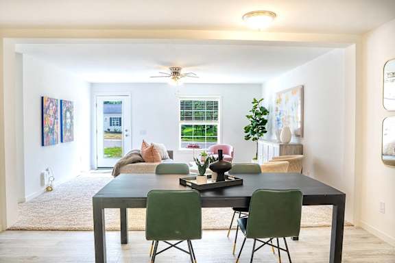 A dining room with a table and chairs.